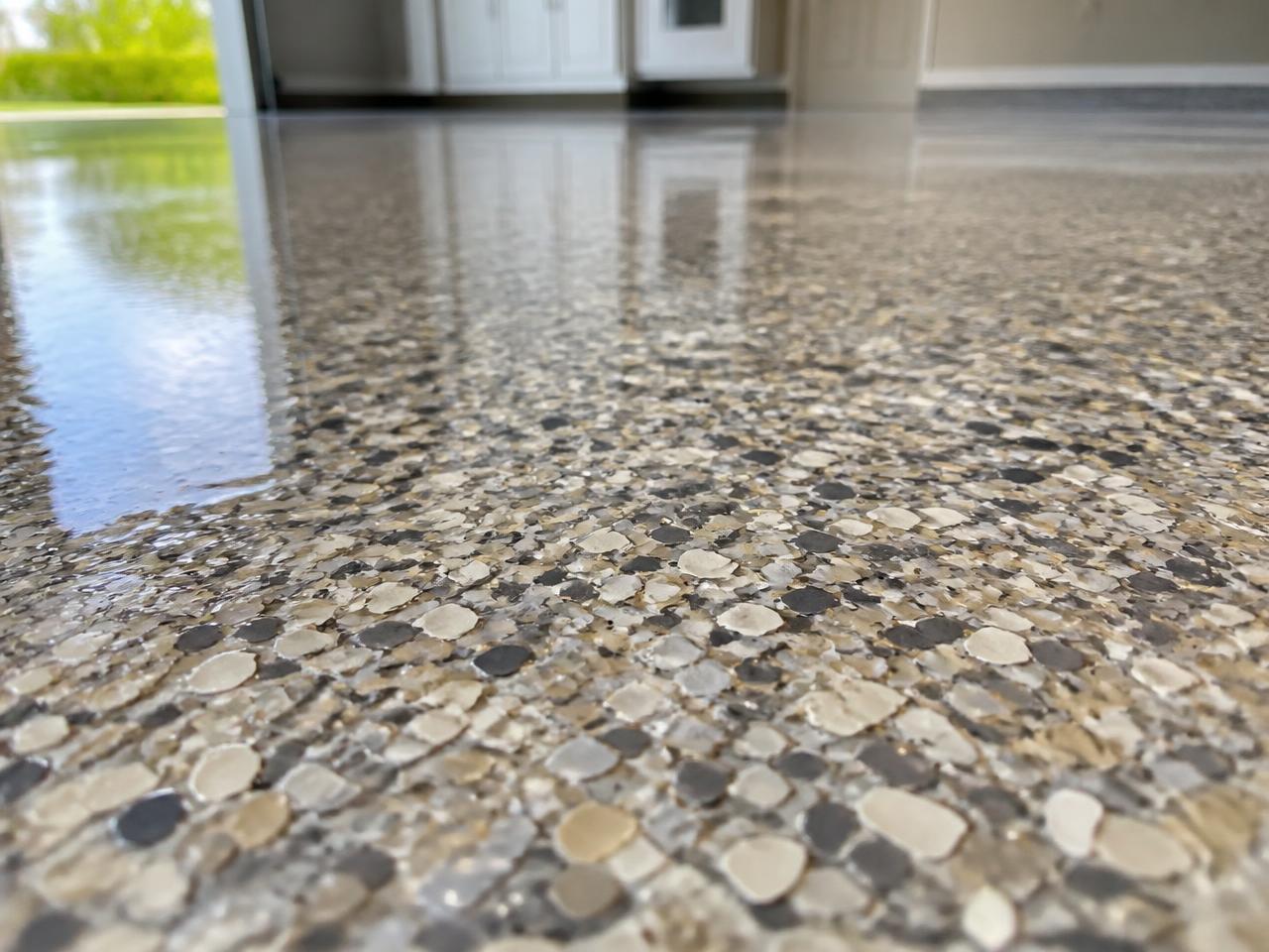 Close-up of decorative epoxy flake chips in a high-gloss clear coat